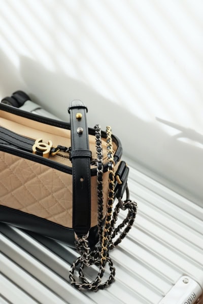 chanel bag rimowa suitcase